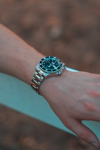 Person wearing a silver watch on bracelet